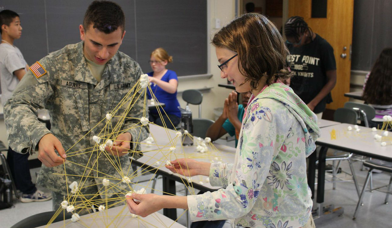 West Point graduate helping students with science experiment, Robin Andrews