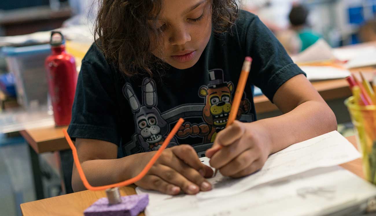 Young child working on schoolwork, Robin Andrews